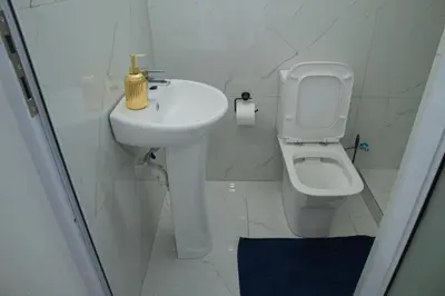 a white bathroom with a sink and a toilet at One Bedroom apartment A3 in Cape Town