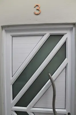 a garage door with the number three on it at One Bedroom apartment A3 in Cape Town