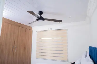a ceiling fan in a room with a closet at One Bedroom Apartment A4 in Cape Town