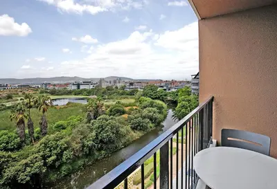 a balcony with a view of a river at Waters Edge Uno in Cape Town
