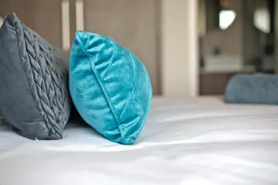 two blue pillows sitting on top of a bed at Waters Edge Uno in Cape Town