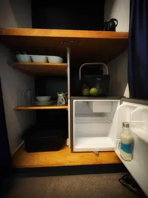 an open refrigerator with its door open in a kitchen at The Secret Room in Somerset West