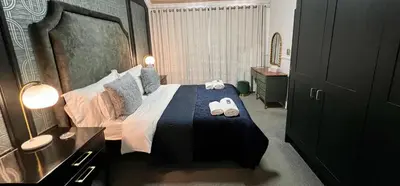 a bedroom with a bed with two towels on it at Vendôme in Somerset West