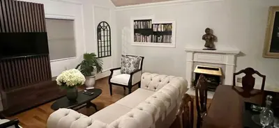 a living room with a white couch and a fireplace at Vendôme in Somerset West