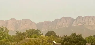 a view of a mountain range with trees and buildings at Vendôme in Somerset West