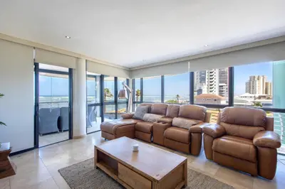 a living room with two couches and a table at Atlantica202 in Strand