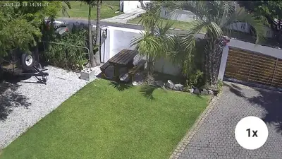 a garden with a bench in the grass at Coco Cabana in Kleinmond