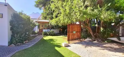 a yard with a fence and a house at Coco Cabana in Kleinmond