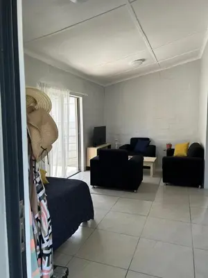 a living room with a bed and a couch at Seewind in Hermanus