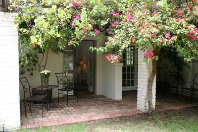an arbor with pink flowers on a patio at Diemersfontein Wine & Country Estate in Wellington