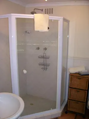 a shower with a glass door in a bathroom at Diemersfontein Wine & Country Estate in Wellington