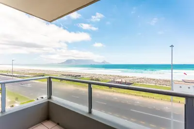 a balcony with a view of the beach and the ocean at Sea Spray B303 by CTHA in Cape Town