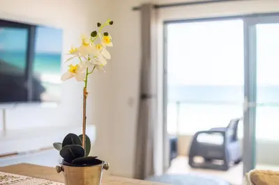 a flower in a pot on a table at Sea Spray B303 by CTHA in Cape Town