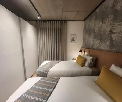 a hotel room with two beds and a window at 308 Bridgewater One - Two Bedroom Apartment with Park Views in Cape Town