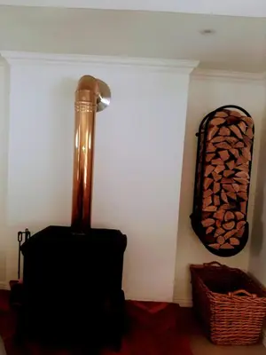 a corner of a room with a lamp and a fireplace at 3 Jongens Villa in Voëlklip