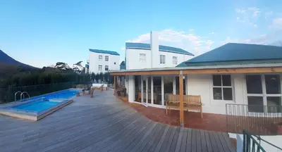a house with a deck and a swimming pool at 3 Jongens Villa in Voëlklip