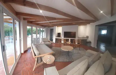 a living room with a couch and a tv at 3 Jongens Villa in Voëlklip