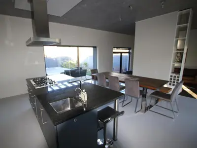 a kitchen and dining room with a sink and a table at Misty Mountain in Strand