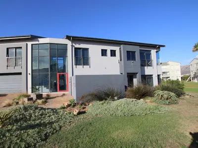 a large white house with a red door at Misty Mountain in Strand