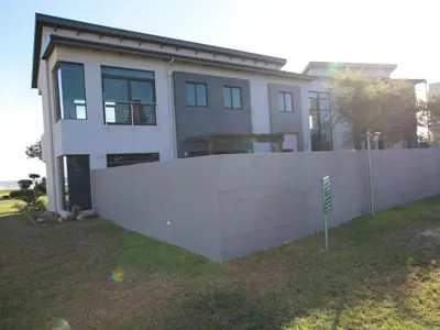 a white house with a fence in front of it at Misty Mountain in Strand