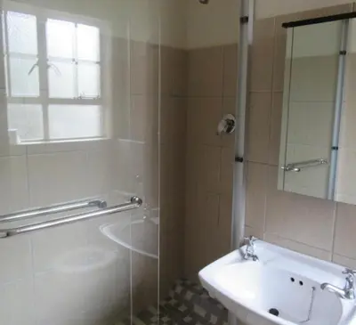 a bathroom with a shower and a sink and a tub at 151 Gie Road in Cape Town