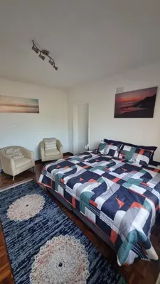 a bedroom with a bed with a colorful comforter at Acanthus Circle in Cape Town