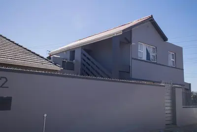 a white house with a fence in front of it at Cape Dreamland in Cape Town