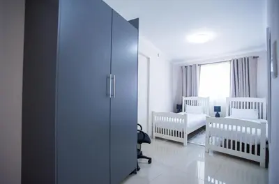 a room with two cribs and a room with a bedroom at Cape Dreamland in Cape Town