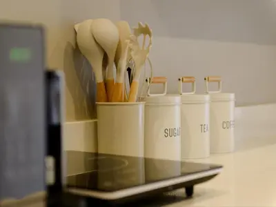 a container filled with cooking utensils on a counter at Stellenbosch Luxury Apartments in Stellenbosch