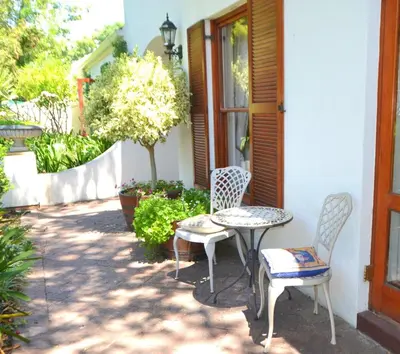 two chairs and a table on a patio at Lovely Family Home in the Winelands in Cape Town