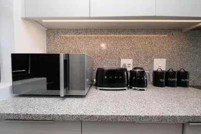 a kitchen counter with a microwave and a toaster oven at Burmeister 302 - Beach Front Views with Onsite Parking in Cape Town
