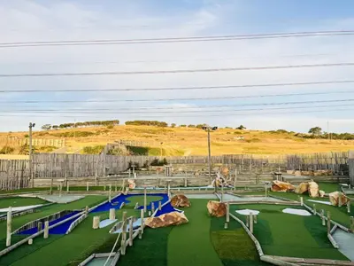 a playground with rocks and slides in a park at Budapest Boutique Hotel in Edgemead