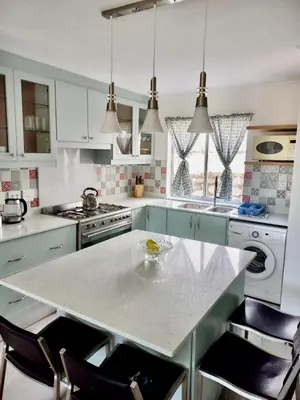 a kitchen with white cabinets and a white counter top at Whale Rock Estate Four 1 in Hermanus