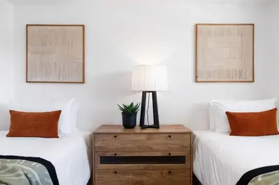 a bedroom with two beds and a lamp on a dresser at Odeon Towers 1007 by Host Agents in Cape Town