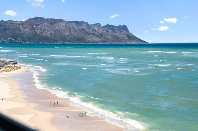 a group of people on a beach near the ocean at Odeon Towers 1007 by Host Agents in Cape Town