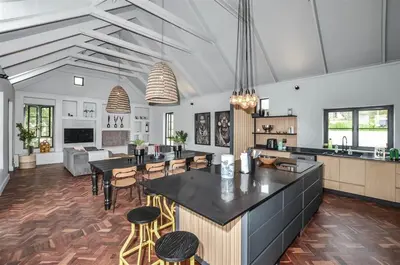 a kitchen and living room with tables and chairs at 4 Bedroom Farm House in Brackenfell