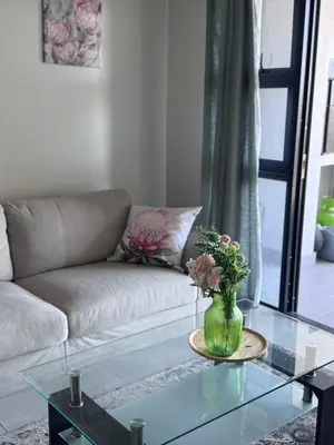 a living room with a couch and a glass table at Protea house in Cape Town
