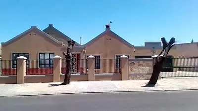 two sculptures of trees in front of a house at Sisonke Guest House in Cape Town