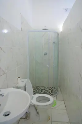a bathroom with a shower and a toilet and a sink at paradise guest house in Cape Town