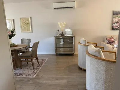 a living room with a table and chairs at Le Bourgette 28 Misty Wink in Franschhoek