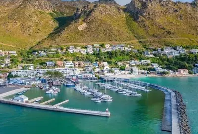 an aerial view of a marina with boats in the water at Gordon's bay - Sea view apartment in Cape Town
