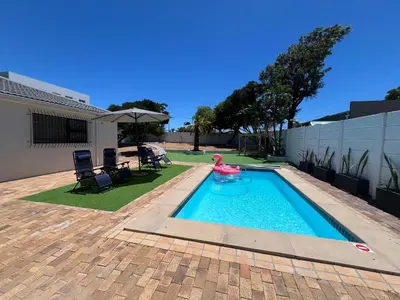 a swimming pool with a pink flamingo in a yard at Luxury 14 sleeper villa Lamsyh in Cape Town