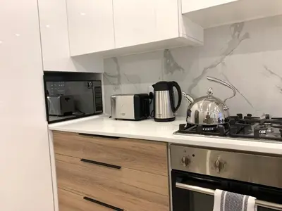 a kitchen with a stove with a tea pot on it at Luxury 14 sleeper villa Lamsyh in Cape Town
