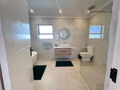 a bathroom with a sink toilet and a mirror at Luxury 14 sleeper villa Lamsyh in Cape Town