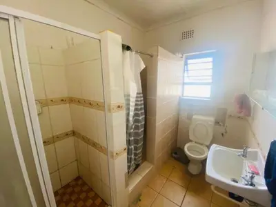 a bathroom with a shower and a toilet and a sink at Eliot TM in Cape Town