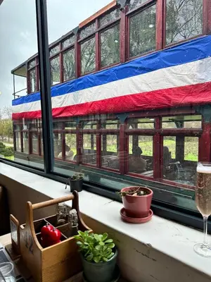 a window with an american flag on a train at Le Bourgette - Close to Town With Great Views in Franschhoek