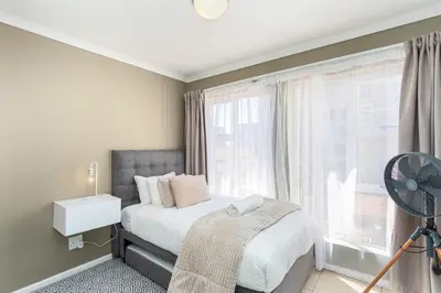 a bedroom with a bed and a large window at Villa Italia 933 by CTHA in Cape Town