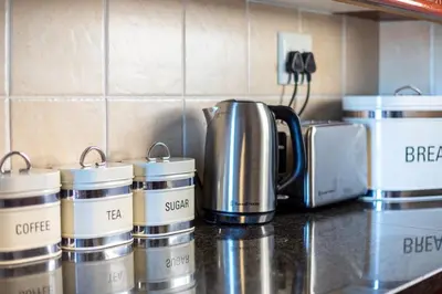 a group of coffee pots sitting on top of a counter at Villa Italia 933 by CTHA in Cape Town