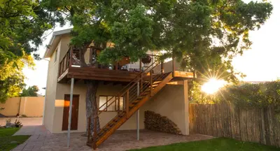 a tree house with a staircase on the side of it at TreeTop Apartment Cape Town in Cape Town