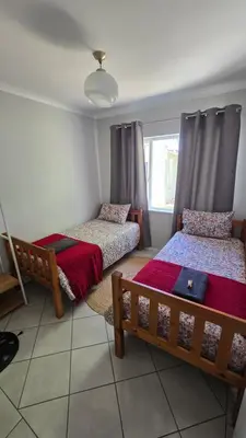 a bedroom with two beds and a window at Watershed Self-Catering in Wolseley